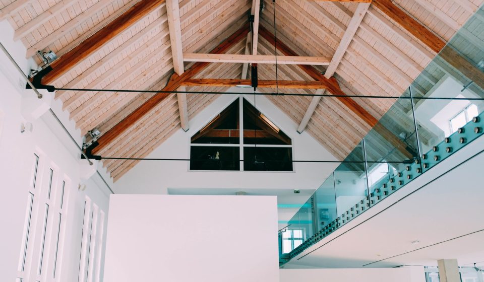 A low angle shot of a wooden ceiling in a cool house with a modern minimalistic interior